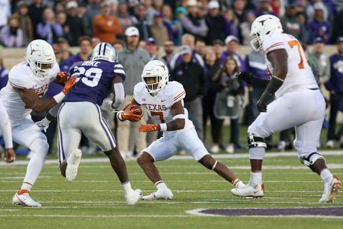 Nov 5, 2022; Manhattan, Kansas, USA; Texas Longhorns running back Keilan Robinson (7) looks for room to run against Kansas State Wildcats linebacker Khalid Duke (29) during the first quarter at Bill Snyder Family Football Stadium. Mandatory Credit: Scott Sewell-USA TODAY Sports